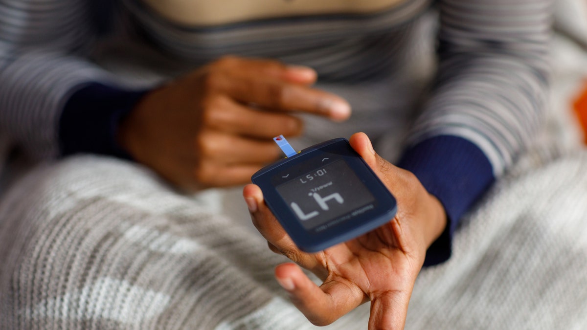 Woman by checking the blood sugar