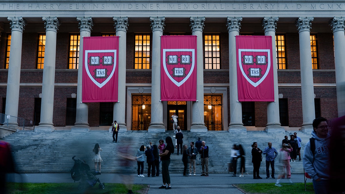 Harvard University banners hang from the building