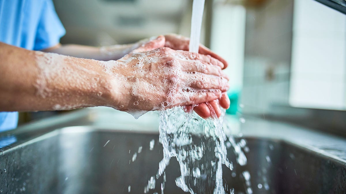 Nurse washing her hands with soap to avoid Covid 19